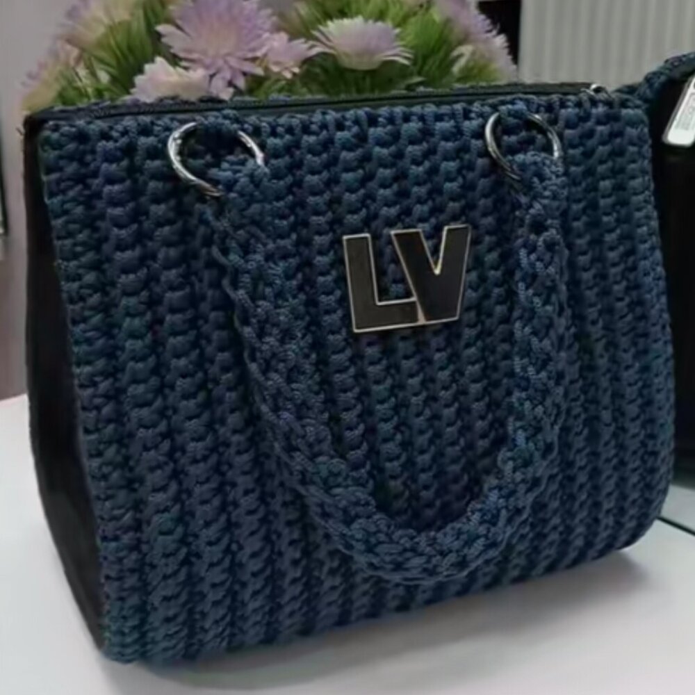 Plum coloured textured crochet bag with black handles and chain detail