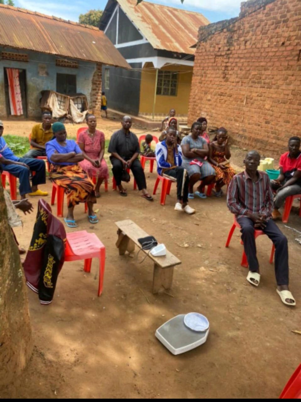 Community members gathered in a courtyard for caregiver support meeting