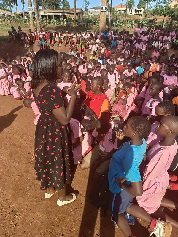 Founder addressing students at a primary school assembly